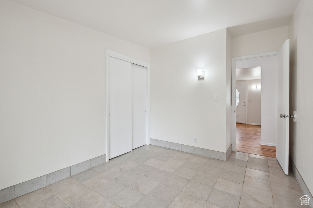 Spare room with light tile patterned floors and baseboards