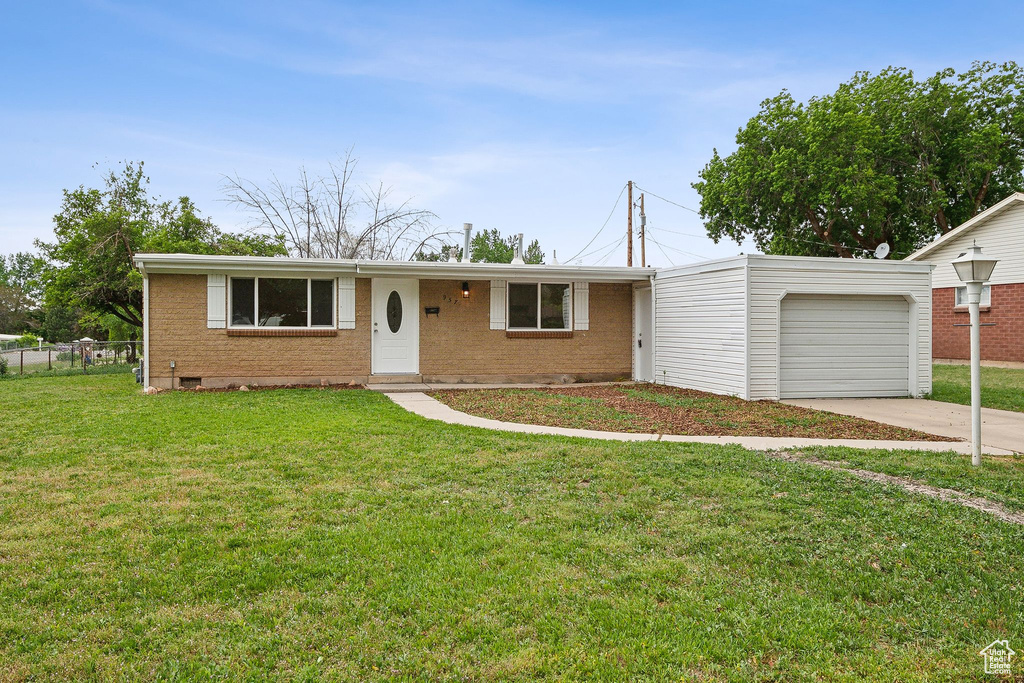Ranch-style home with a garage, brick siding, and concrete driveway