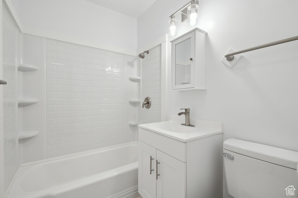 Full bathroom with shower / tub combination, vanity, and toilet