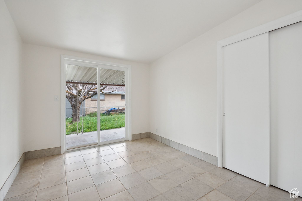 Empty room with light tile patterned floors