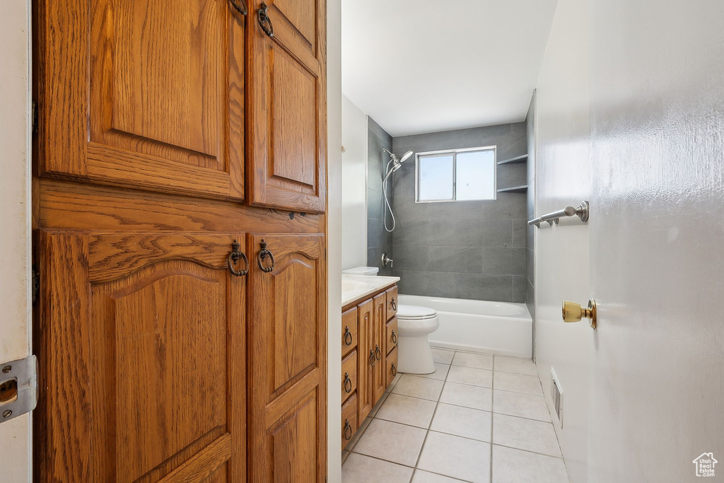 Full bathroom featuring tile patterned flooring, toilet, bathing tub / shower combination, and vanity