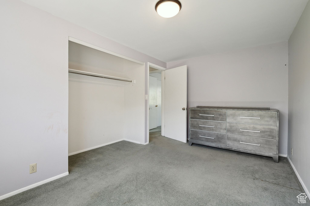 Unfurnished bedroom with carpet, baseboards, and a closet