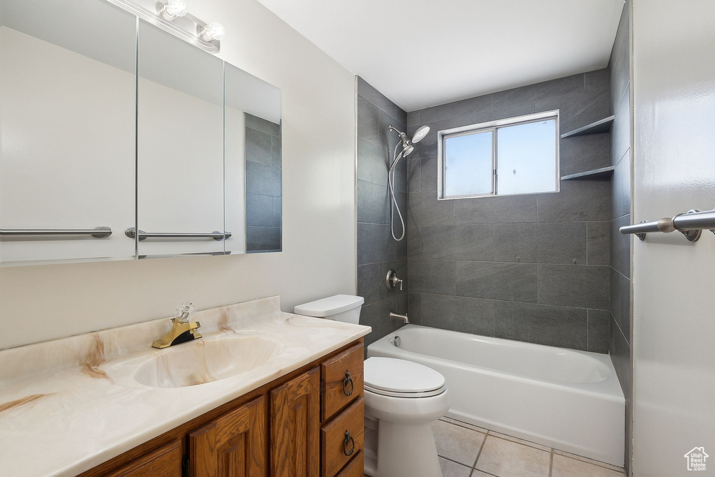 Full bathroom featuring toilet, shower / bathtub combination, tile patterned flooring, and vanity
