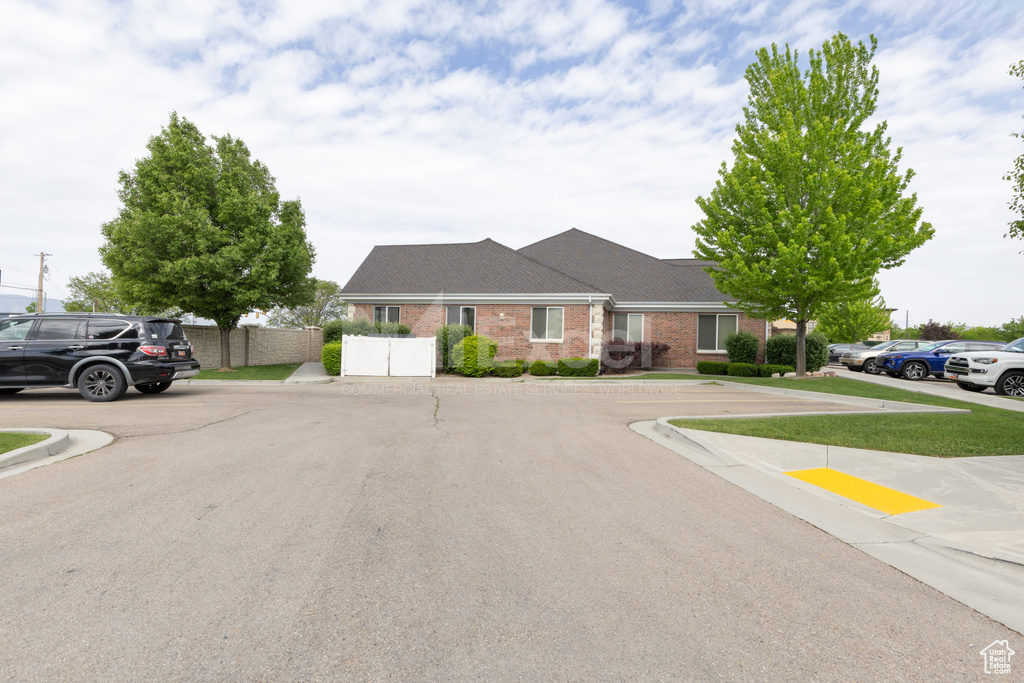 View of front of property with brick siding and fence