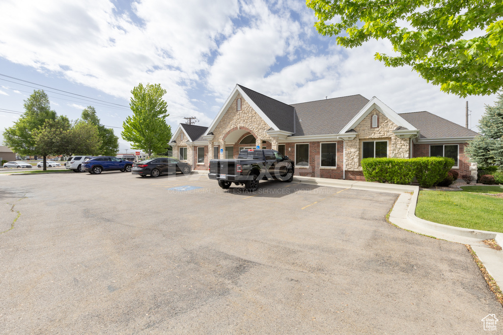 View of property with uncovered parking