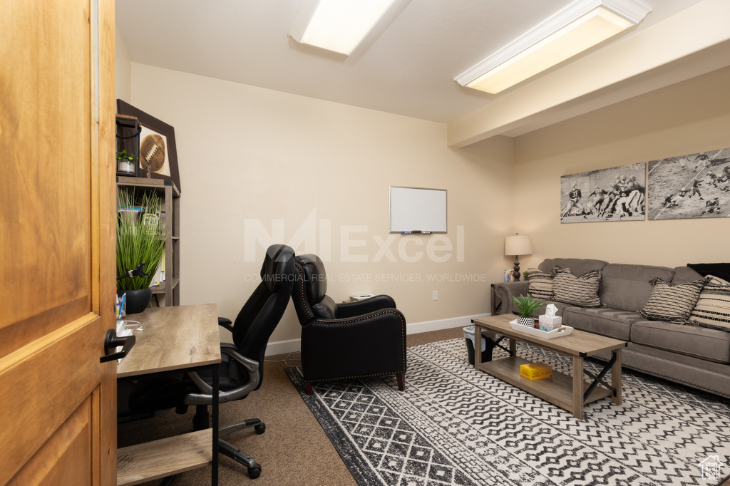 Carpeted office featuring baseboards