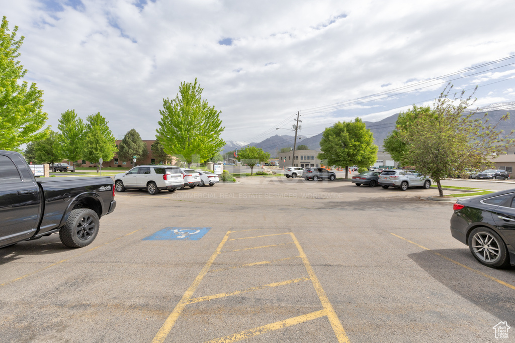 Uncovered parking lot featuring a mountain view