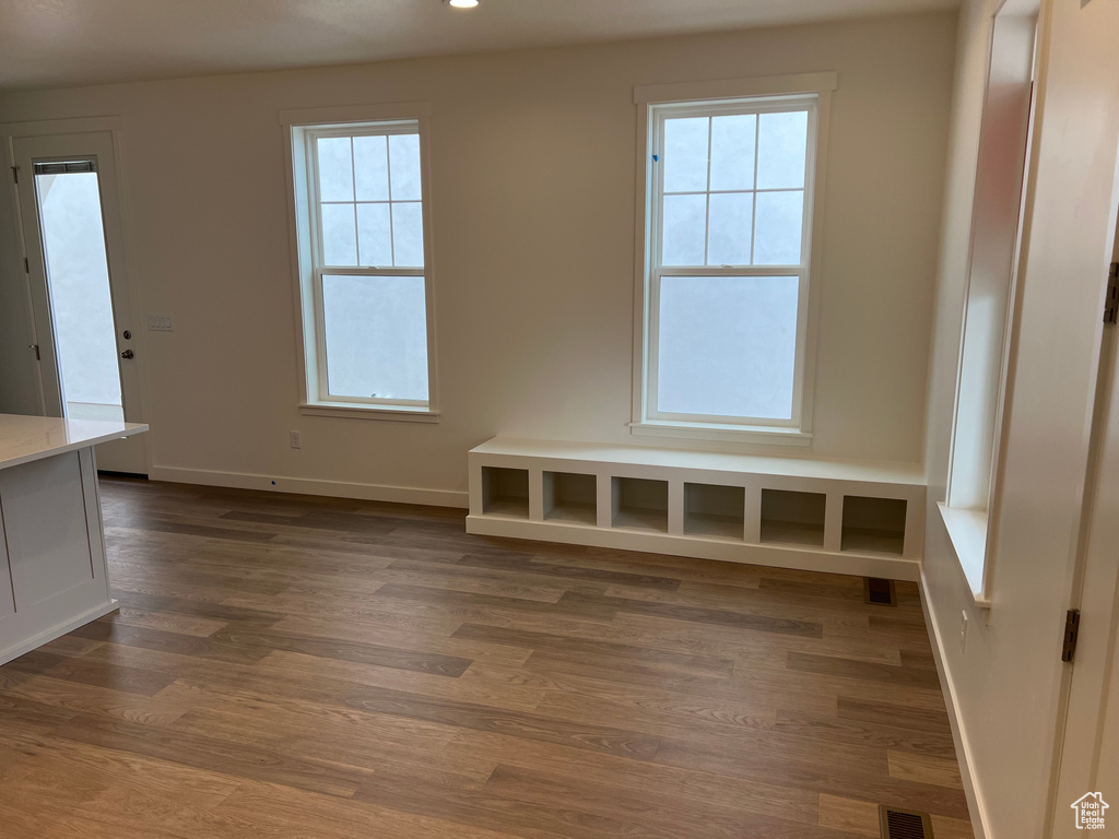Unfurnished dining area with dark wood-style flooring and recessed lighting