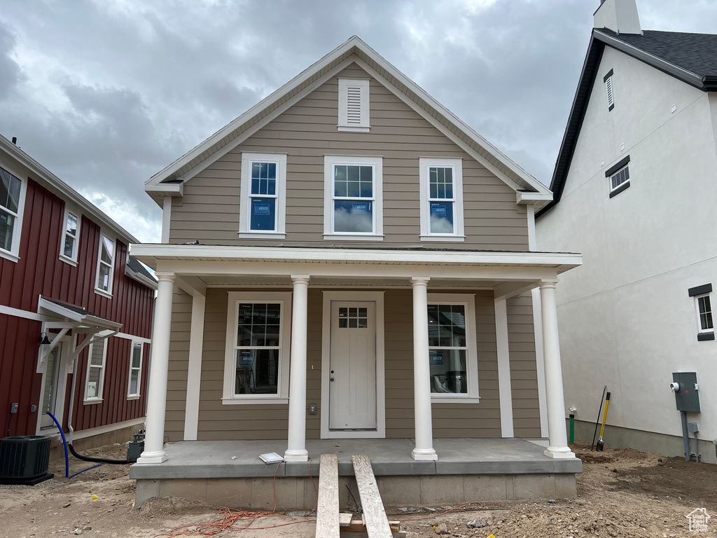 View of front of property featuring covered porch and central air condition unit