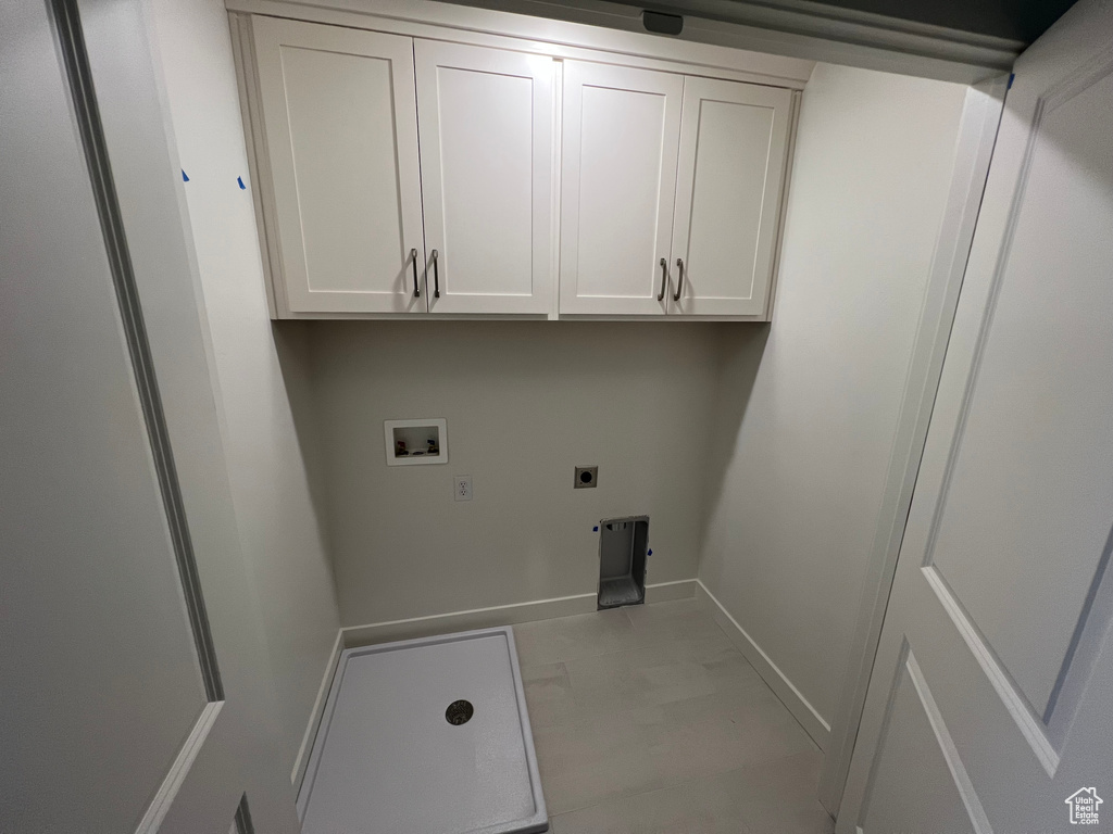 Laundry room with washer hookup, cabinet space, and electric dryer hookup