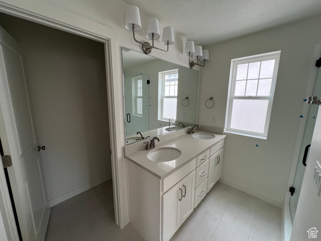 Bathroom featuring double vanity and tile patterned floors