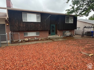 Raised ranch featuring fence and brick siding