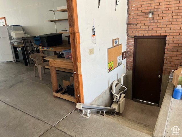 Garage featuring freestanding refrigerator
