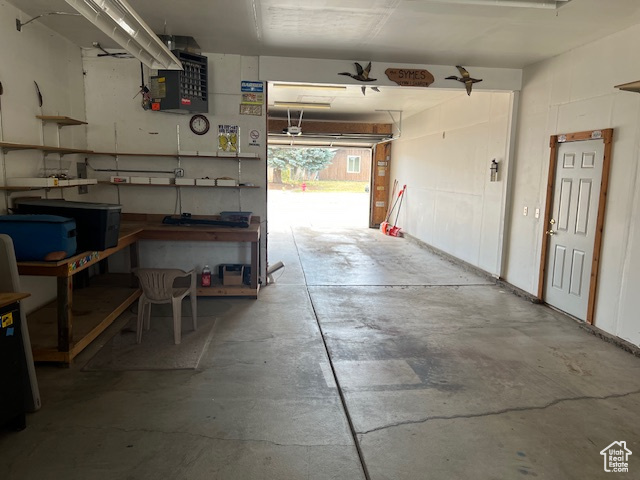 Garage with a workshop area and a heating unit
