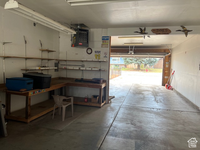 Garage featuring a heating unit and a workshop area