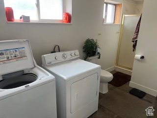 Laundry area featuring washer and clothes dryer and baseboards