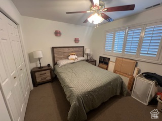 Bedroom featuring a closet, ceiling fan, and carpet flooring