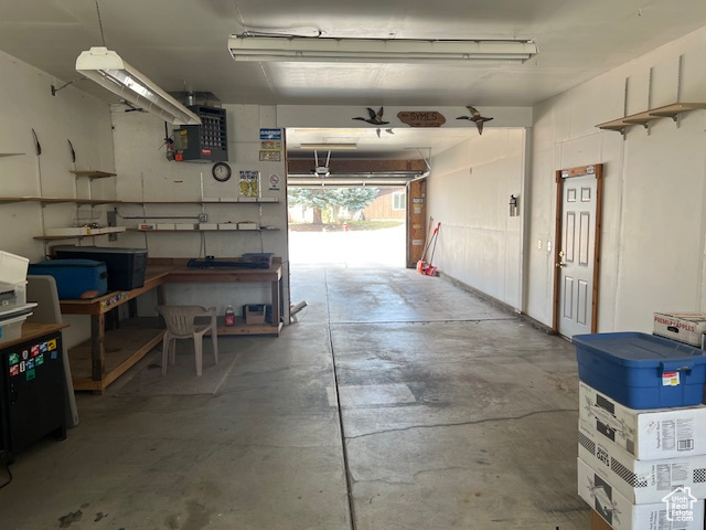 Garage with a workshop area and a heating unit