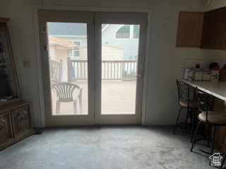 Entryway featuring light carpet