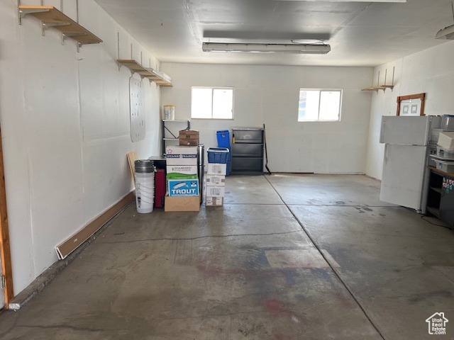 Garage featuring freestanding refrigerator