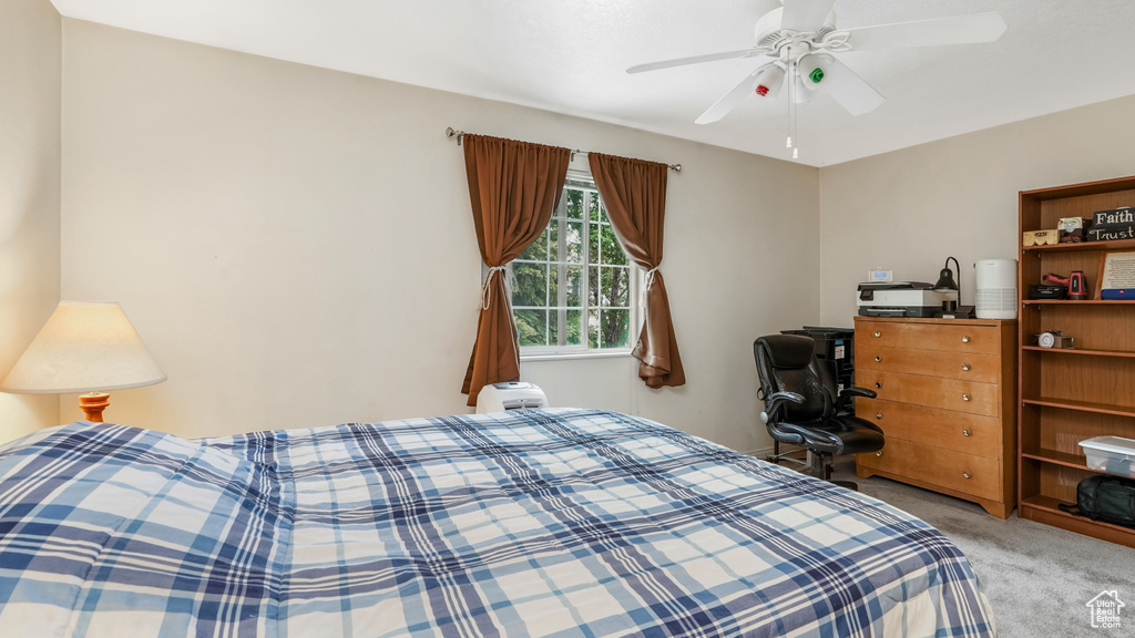 Bedroom with light colored carpet and ceiling fan