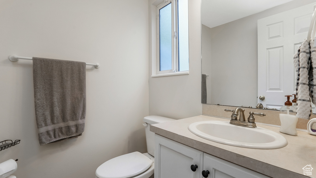 Half bathroom featuring toilet and vanity