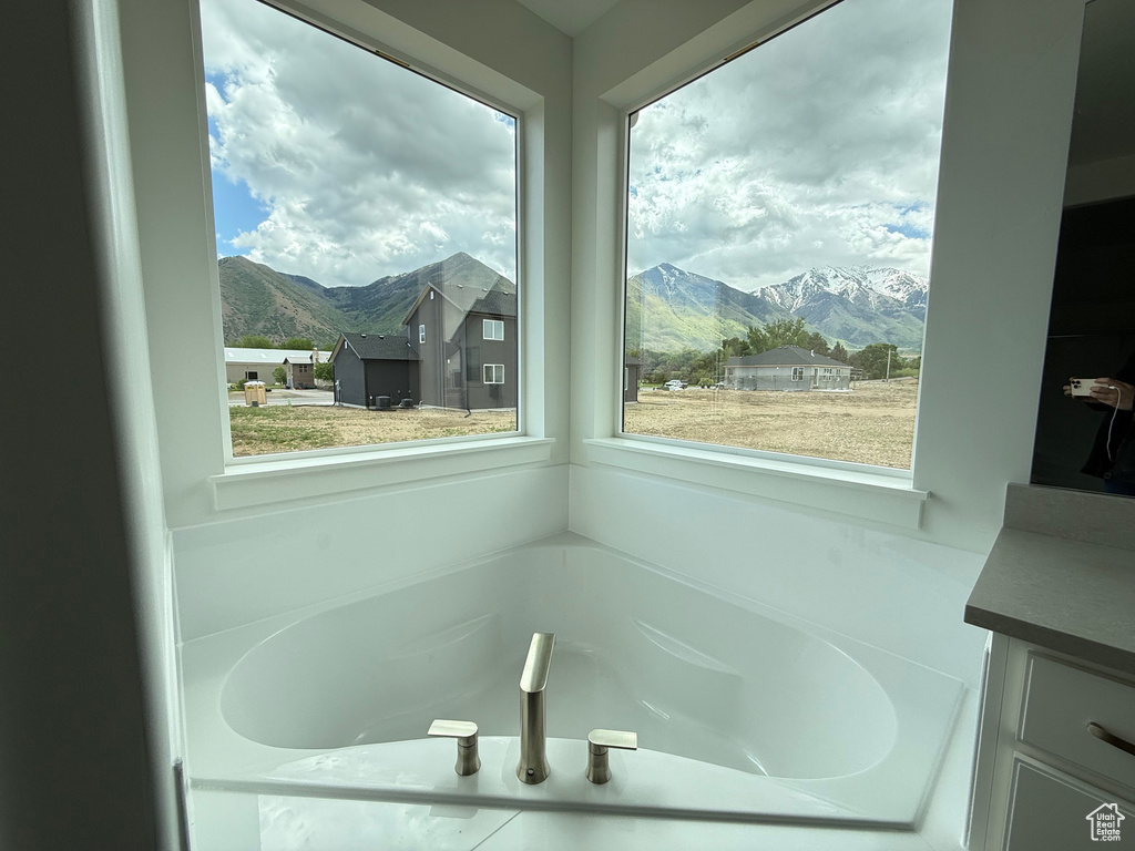 Full bath with a mountain view, a bath, and vanity