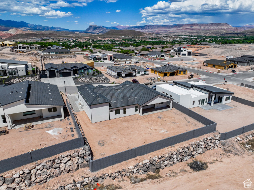 Aerial view of residential area featuring a mountainous background