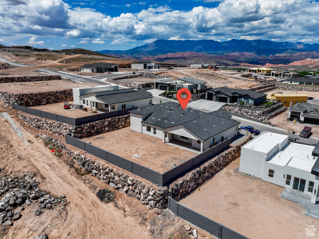 Aerial view of property and surrounding area with a mountainous background