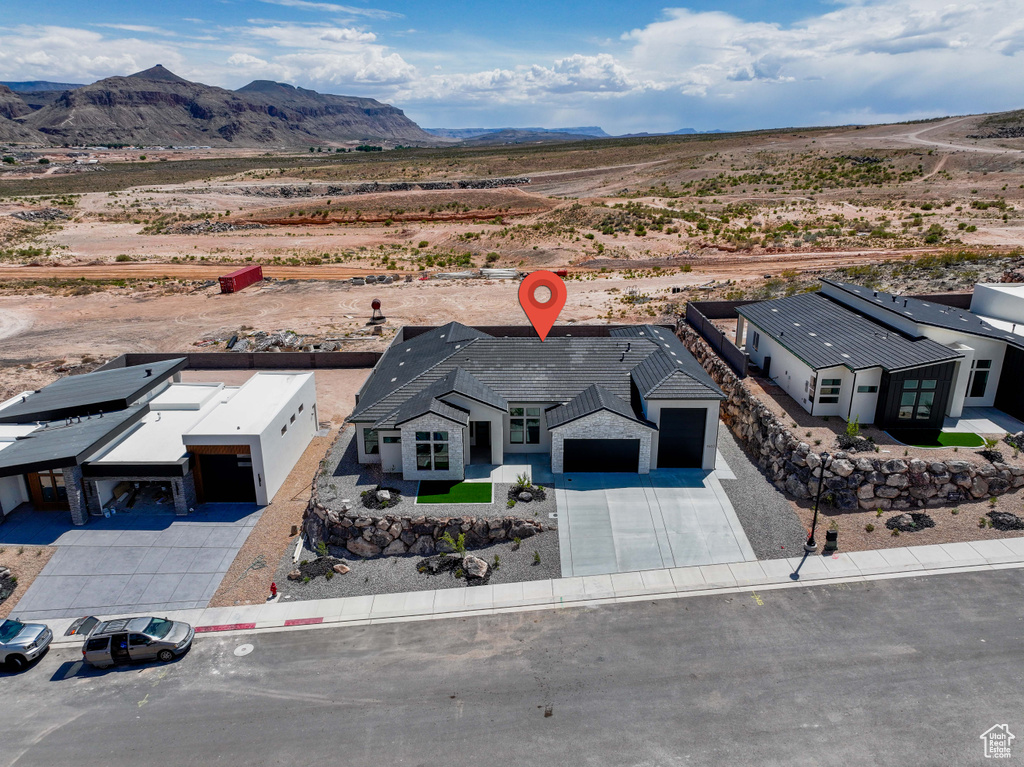 Overview of rural landscape featuring a desert landscape and a mountain backdrop