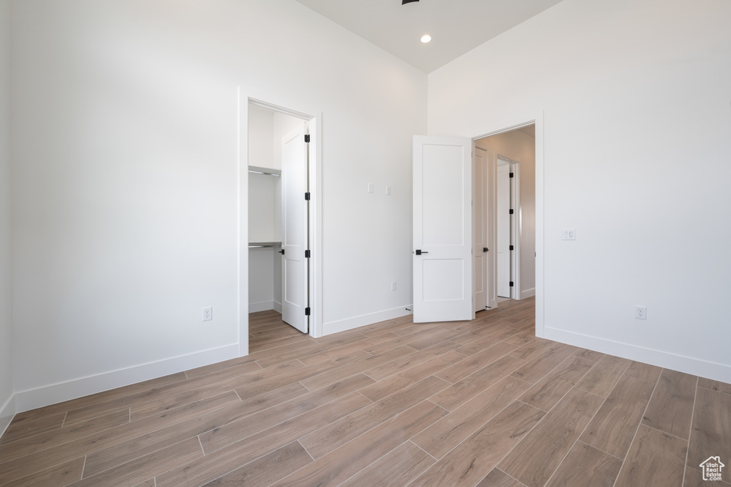 Spare room with light wood-style flooring, baseboards, and recessed lighting