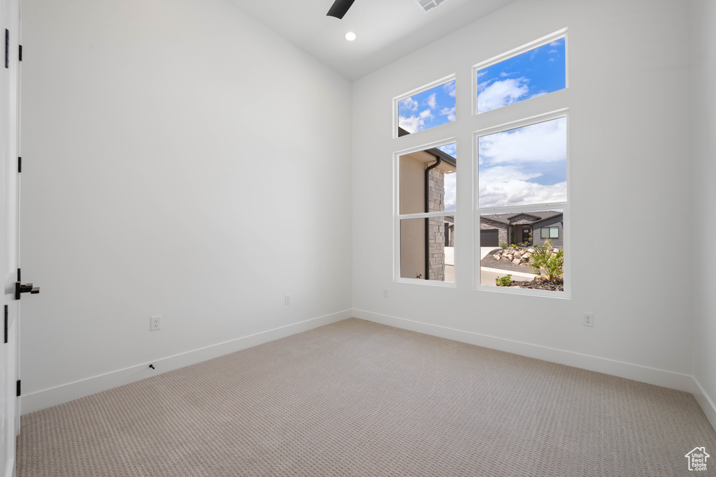 Spare room featuring light carpet, a ceiling fan, baseboards, recessed lighting, and high vaulted ceiling