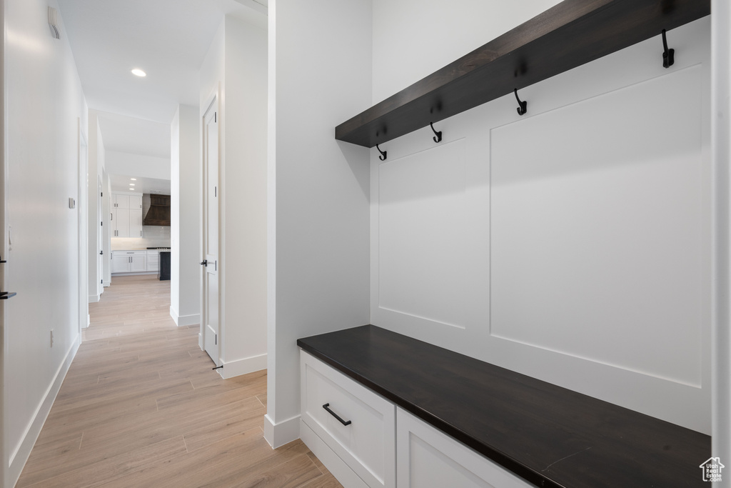 Mudroom featuring light wood-type flooring, baseboards, and recessed lighting
