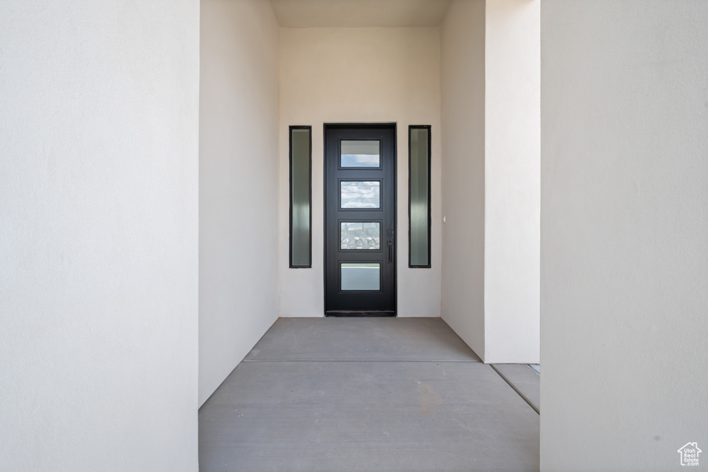 Doorway to property featuring stucco siding