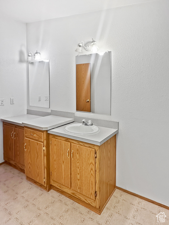 Bathroom featuring vanity and baseboards