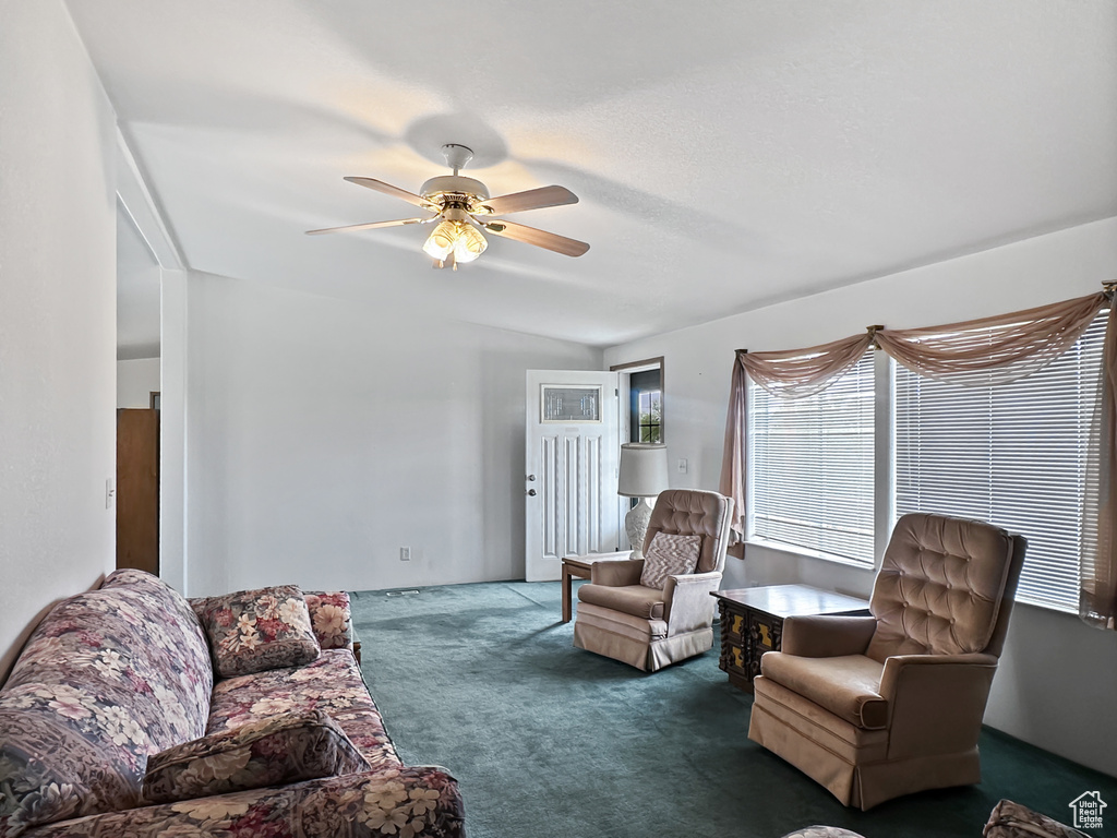 Living area with carpet floors and ceiling fan