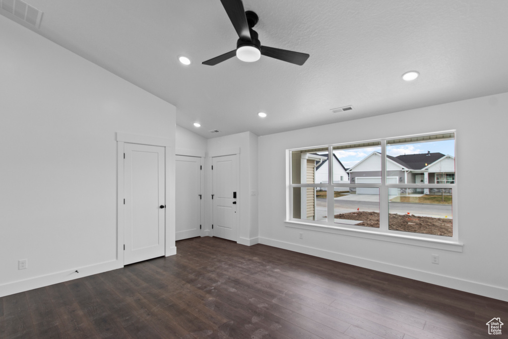 Unfurnished room with baseboards, recessed lighting, dark wood-type flooring, ceiling fan, and vaulted ceiling