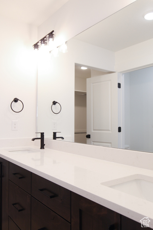 Full bathroom featuring double vanity and recessed lighting
