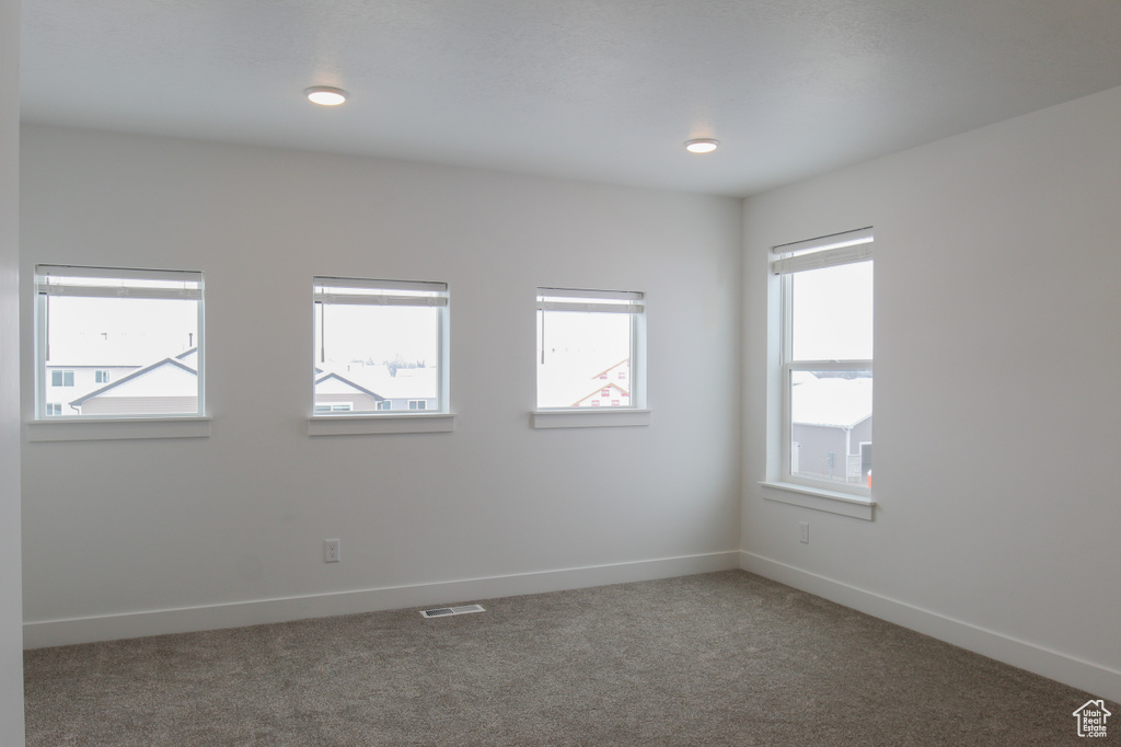 Carpeted empty room with baseboards