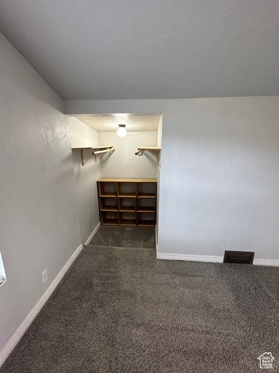 Basement featuring carpet flooring and baseboards