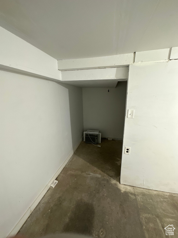 Hall with concrete floors and baseboards
