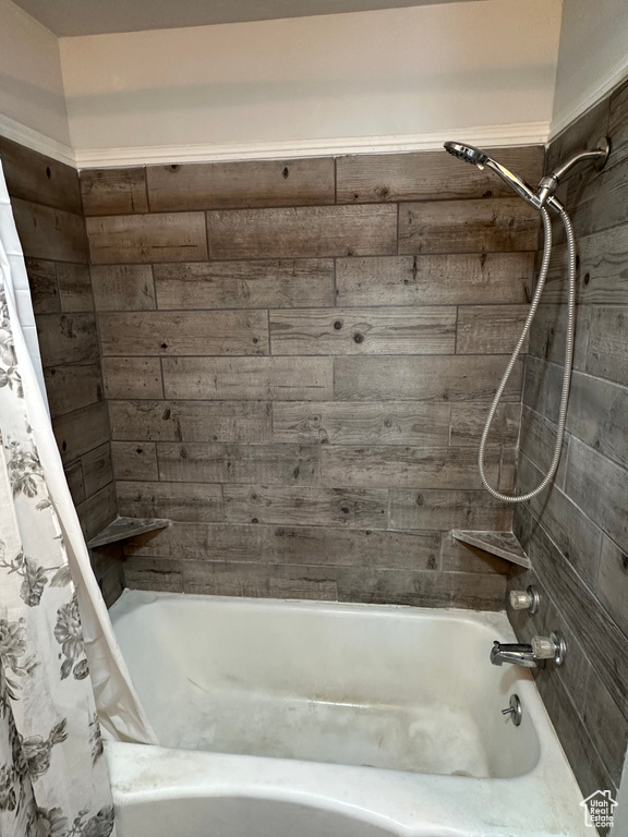 Bathroom with shower / bath combination with curtain