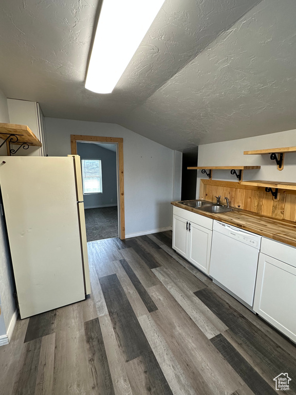 Kitchen featuring white appliances, a sink, open shelves, white cabinets, and lofted ceiling
