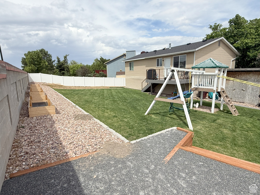 Rear view of house featuring a playground