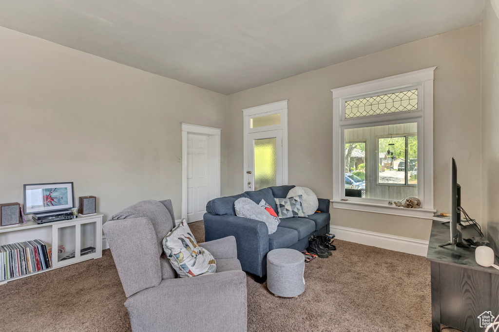 Carpeted living room featuring baseboards
