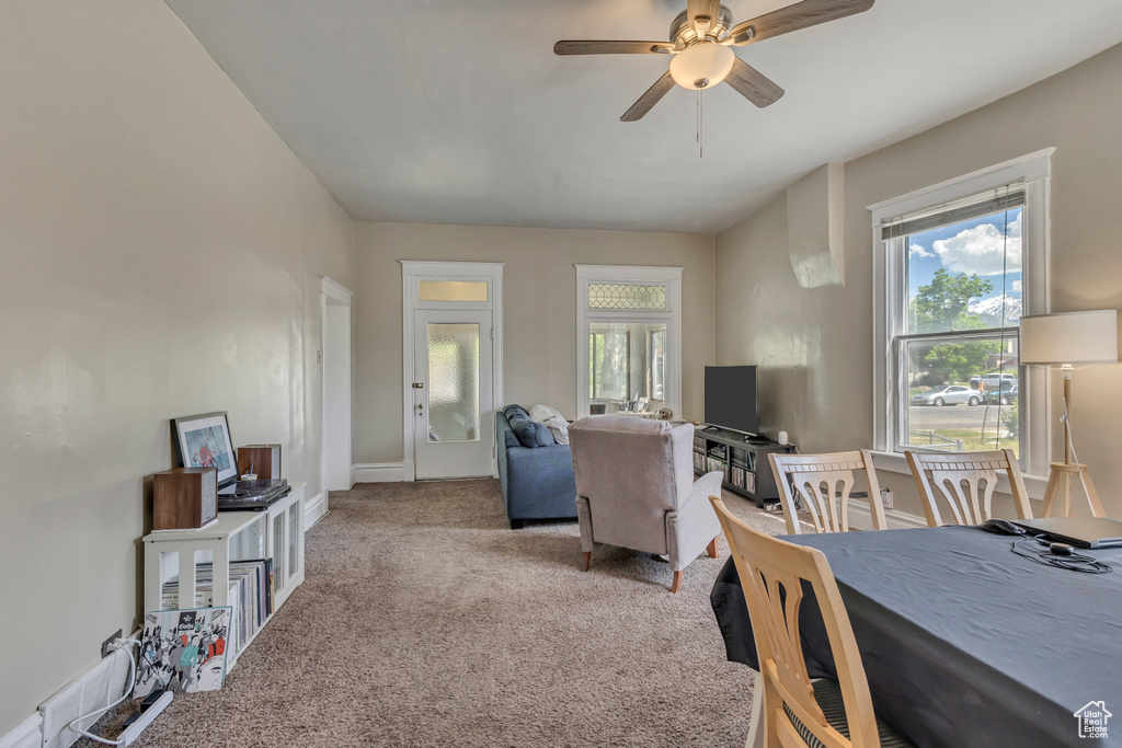 Living room featuring a ceiling fan and carpet flooring