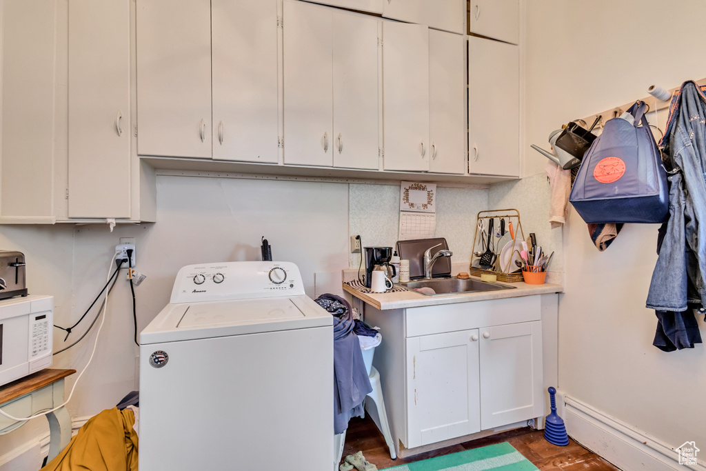 Laundry room featuring washer / dryer, a sink, and a baseboard radiator