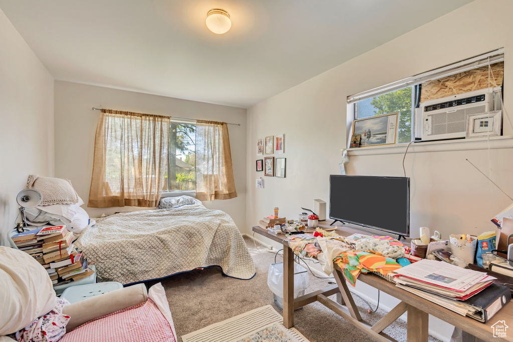 Bedroom featuring cooling unit and carpet floors