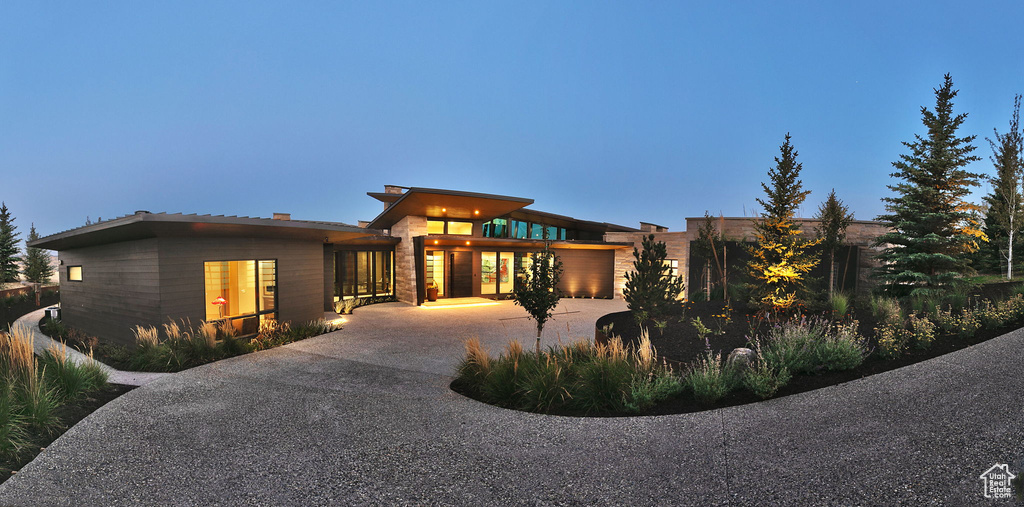 View of front facade with concrete driveway and an attached garage