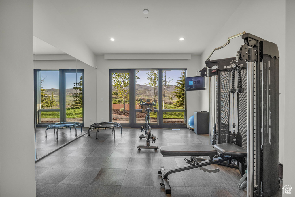 Exercise room with french doors and recessed lighting